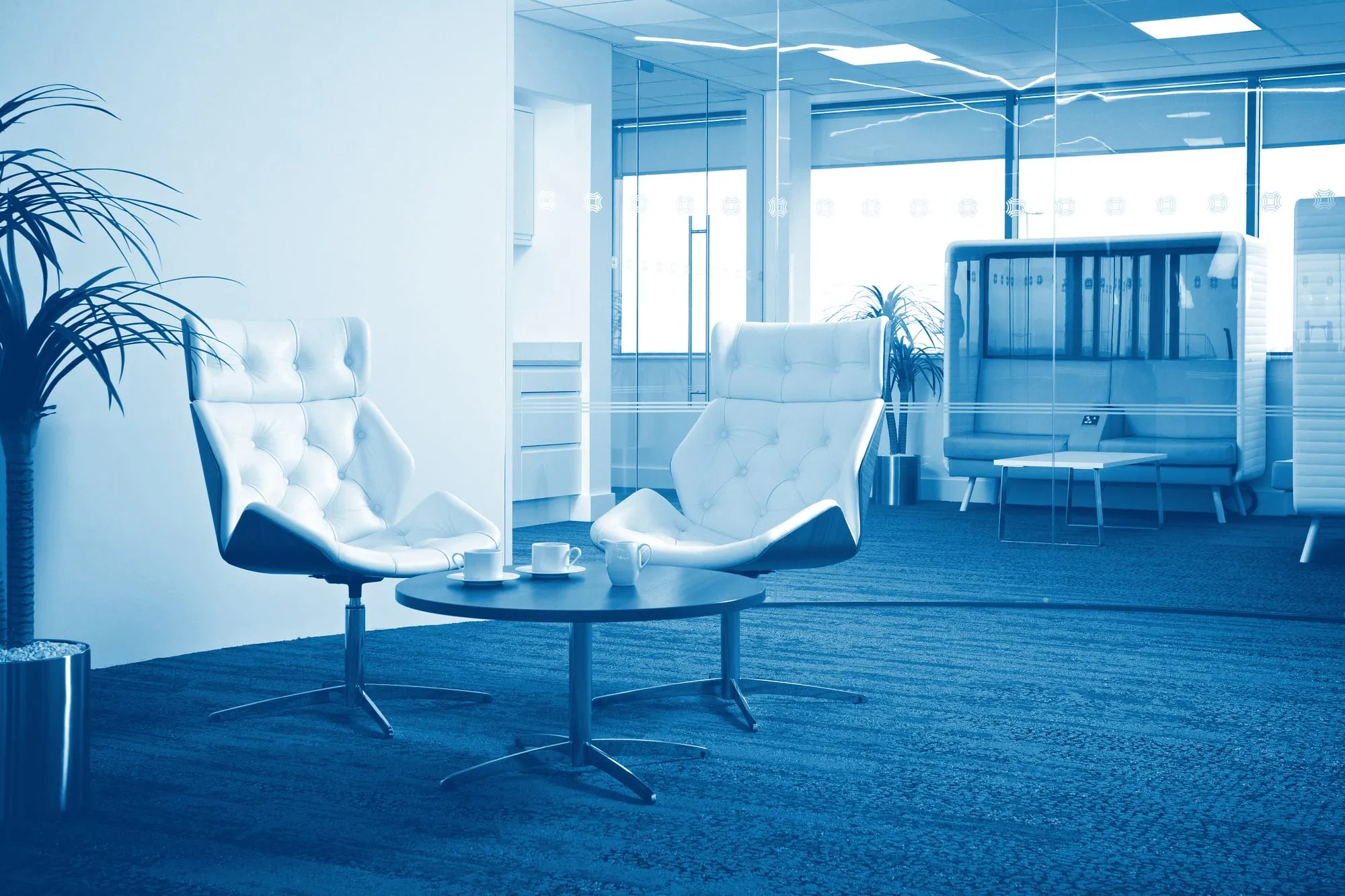 A reception lounge with two armchairs and a coffee table