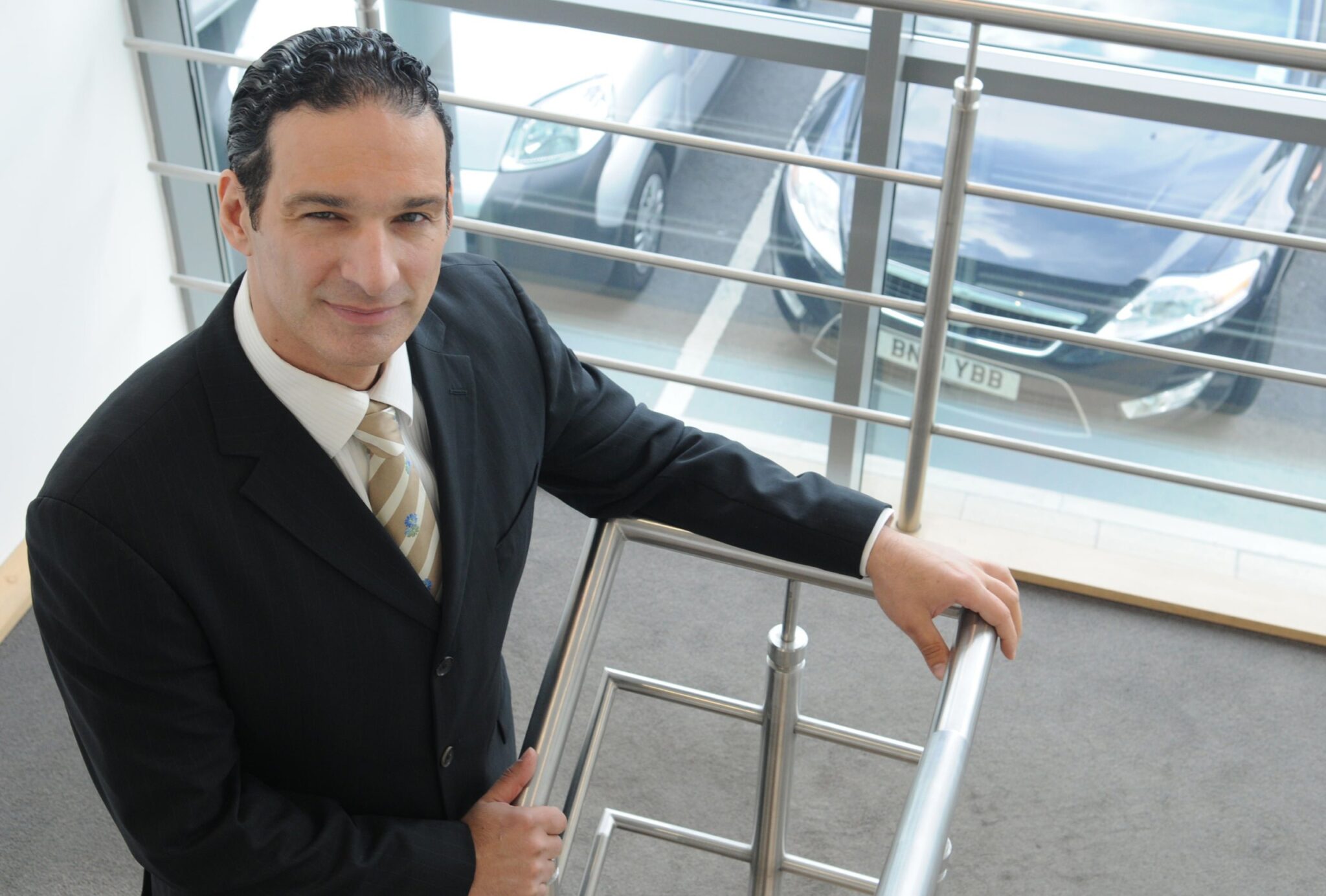 Managing Director Mike Odysseas standing on staircase