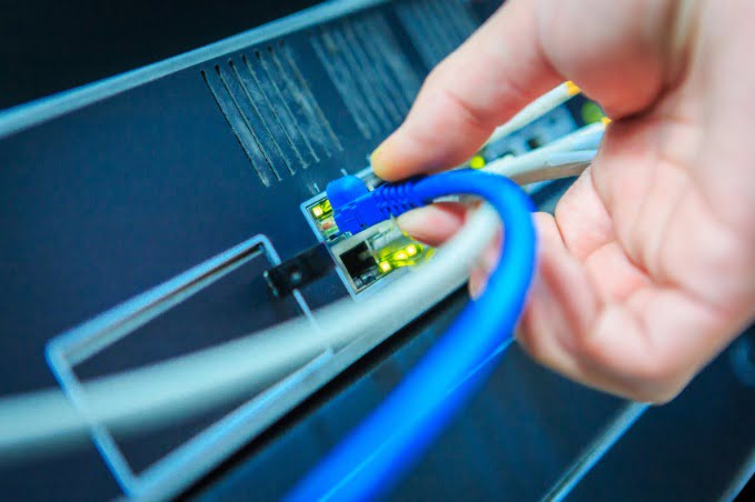 Man attaching network cable 